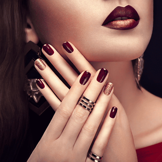 Woman with bright red lips and manicure