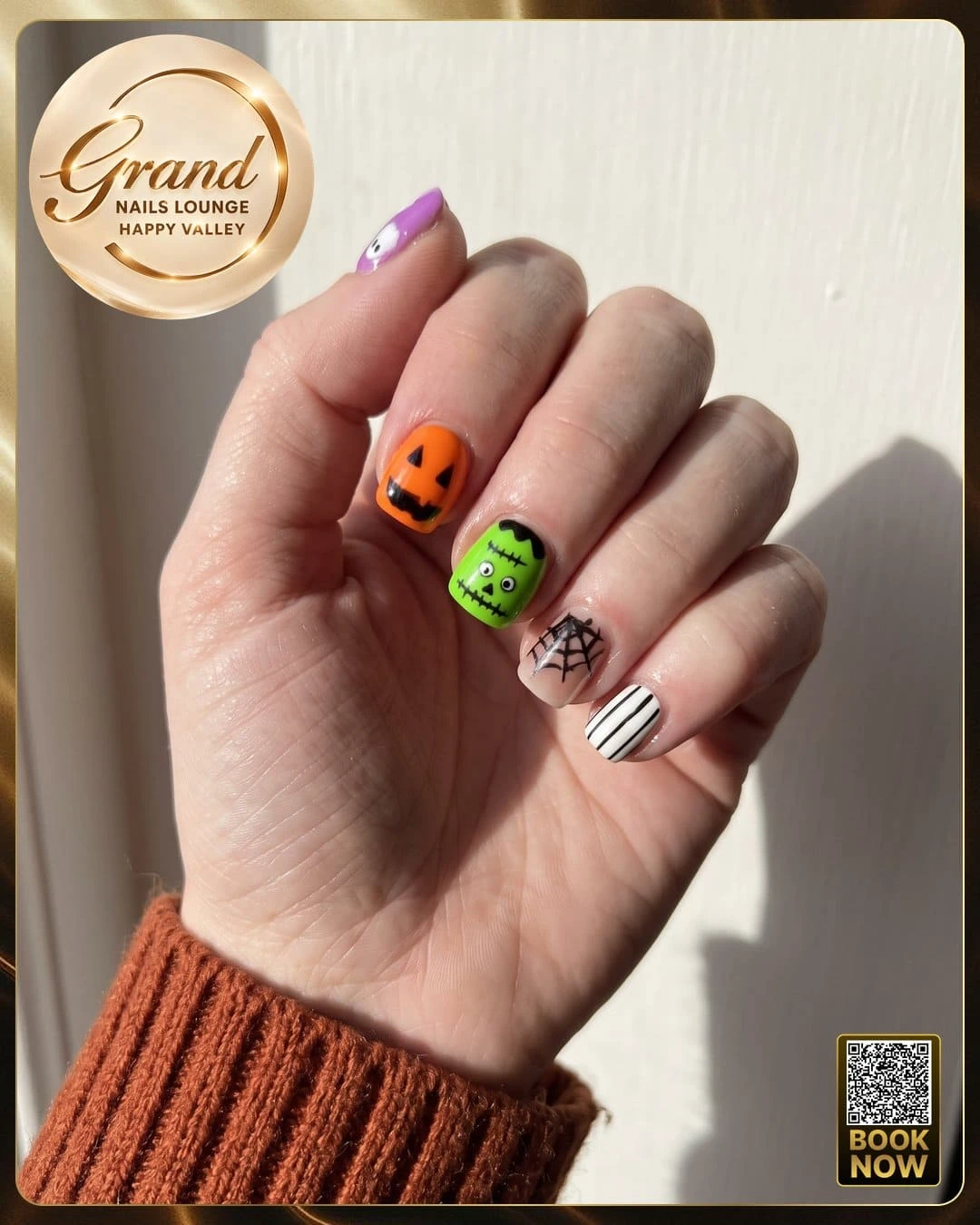 Fun Halloween nail designs featuring a pumpkin face and spiderweb accents