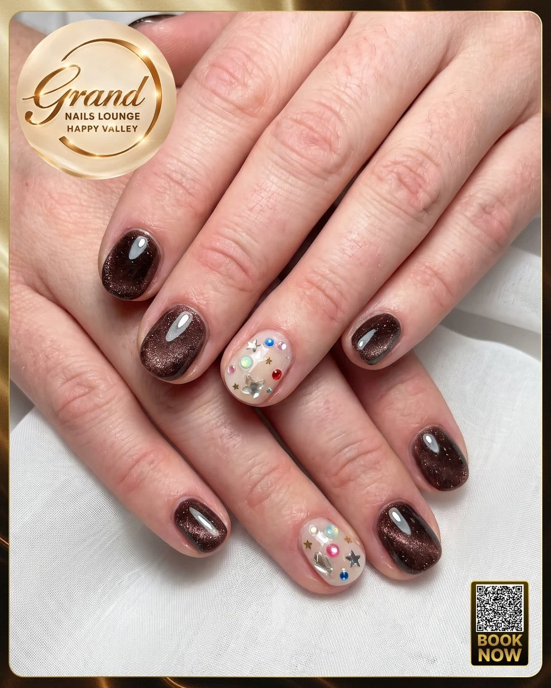 Short round brown cat-eye dip powder nails with gem accents showing healthy cuticle growth