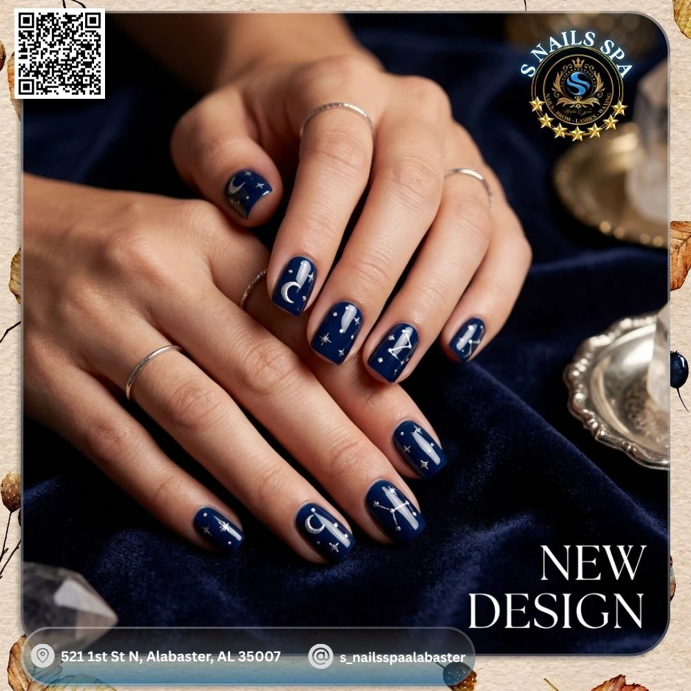 Midnight dark blue nails adorned with silver celestial moons and constellation art