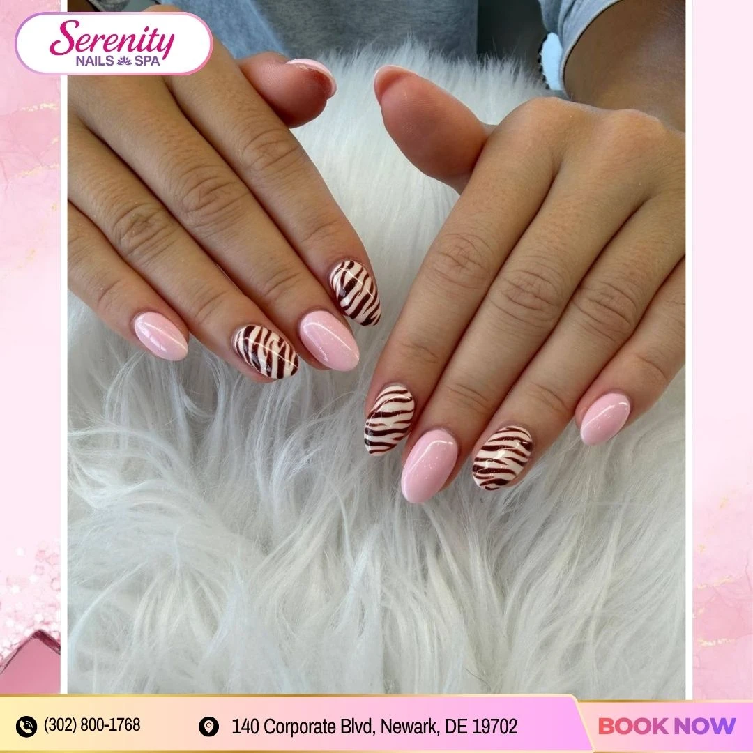 Pink manicure with graphic zebra accent nails at Serenity Nails & Spa