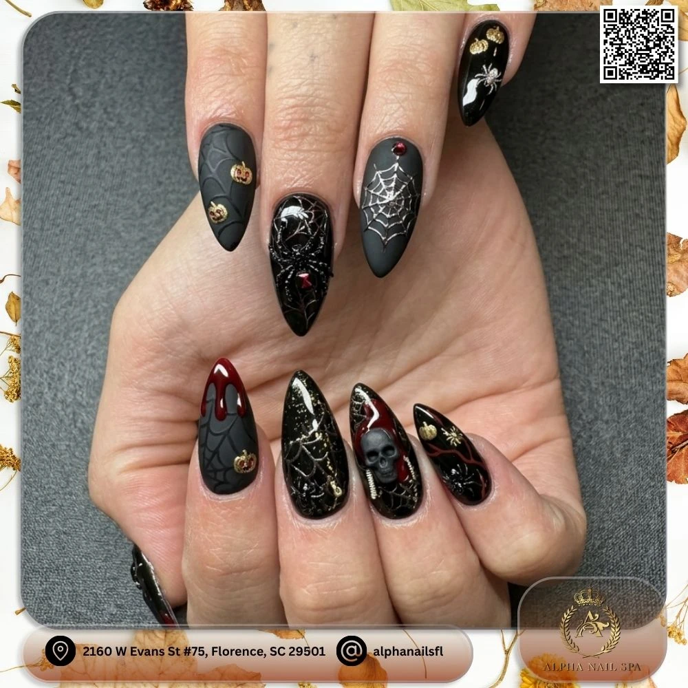 Dark gothic Halloween stiletto nails in matte black and red with 3D skull, spiderweb, and blood drip nail art created at Alpha Nail Spa in Florence SC 29501
