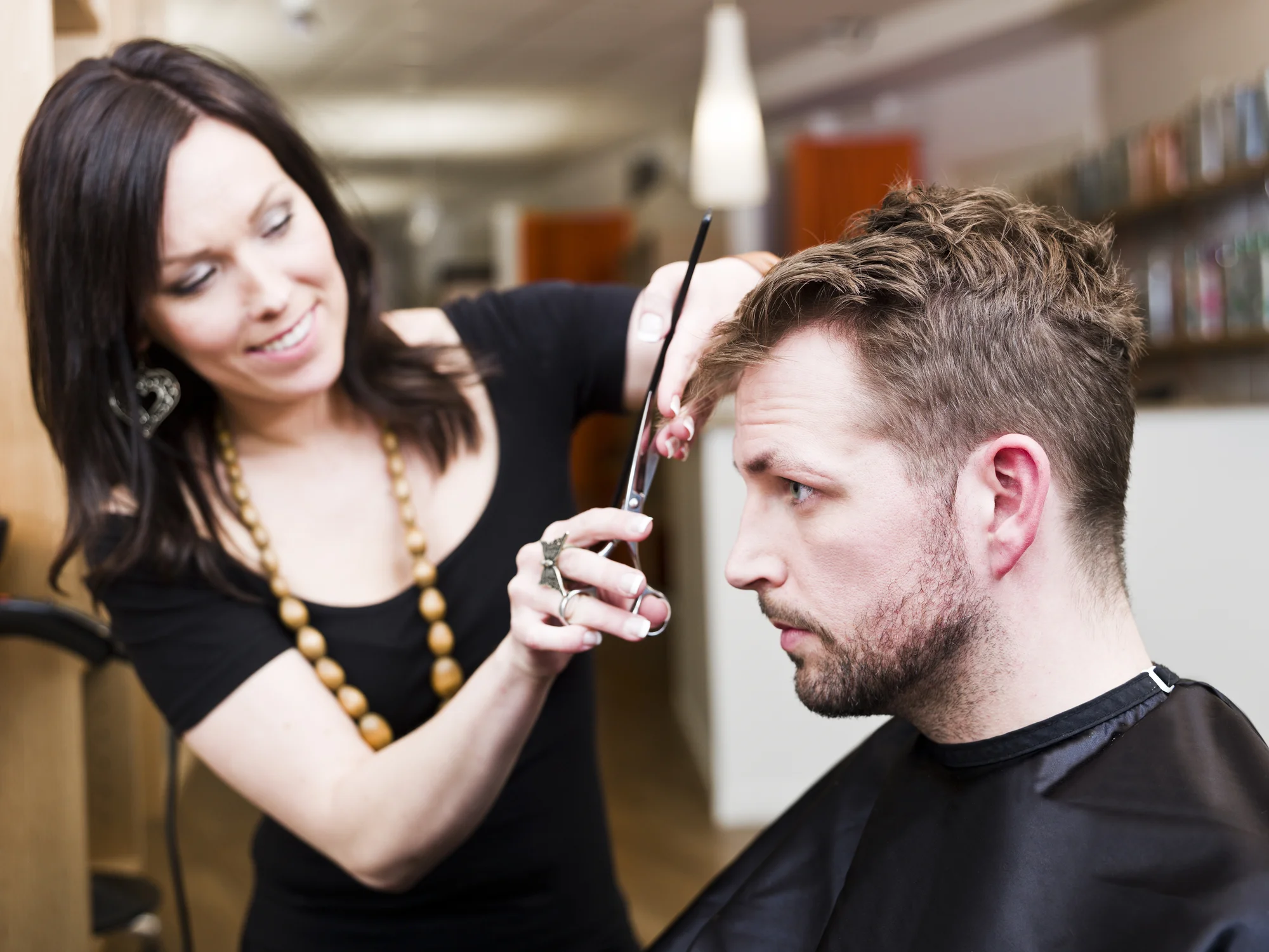 A woman receiving a hair treatment at the salon
